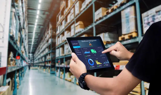 Retail Management professional using a tablet to monitor warehouse inventory and supply chain operations