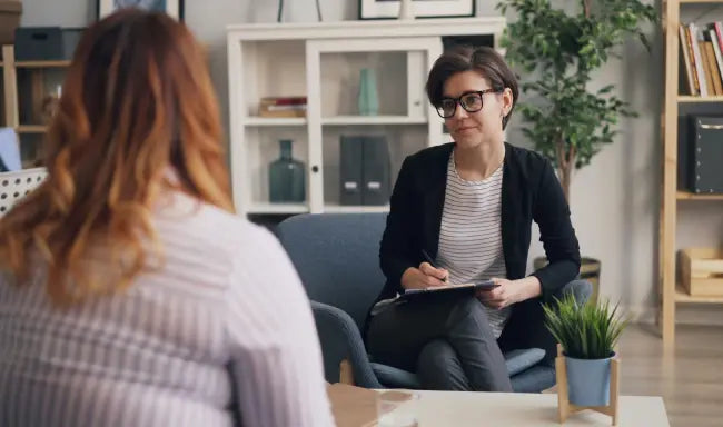 Occupational therapist consulting with a client during a therapy session, providing personalized support and rehabilitation guidance.