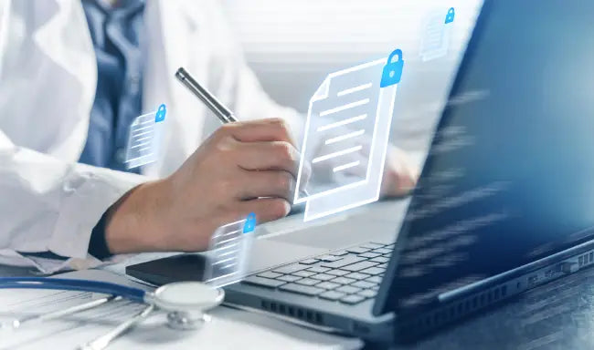 Healthcare professional managing secure electronic health records and digital patient documentation on a laptop