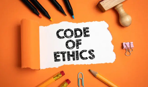 Code of ethics and code of conduct training concept with office stationery and ethics policy document on a desk.