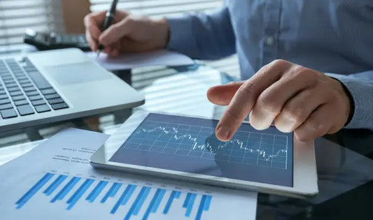 Financial controller analyzing financial data and market trends on a tablet during professional finance training.