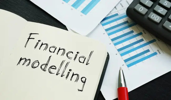 Financial modelling course materials with financial reports, calculator, charts, and notebook for business finance analysis.