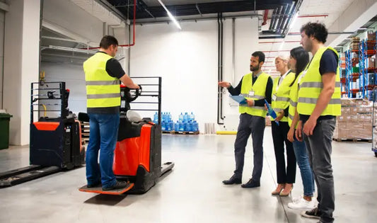 Forklift Training participants learning safe forklift operation and warehouse handling in a modern logistics facility