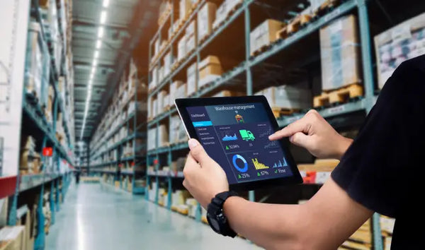 Retail Management professional using a tablet to monitor warehouse inventory and supply chain operations